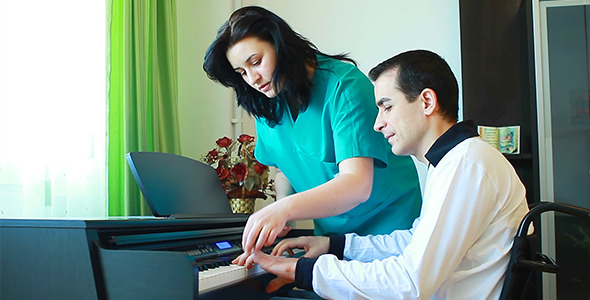 Therapy For Young Man In Wheelchair Using Piano 2
