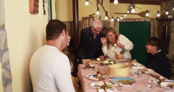 Happy latin family cooking together during dinner time at home