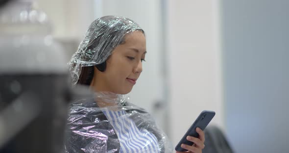 Woman with hair color dye at salon