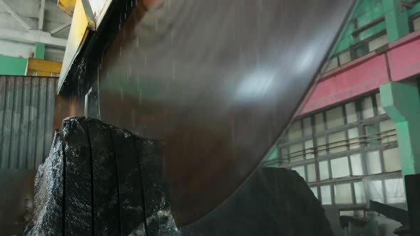 Large Industrial Stone Cutter Cuts Granite Rock Into Plates in Jets of Water Close Up Low Angle