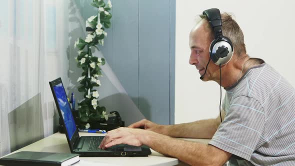 Man Using Laptop Computer at Home.