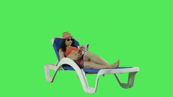 Female relaxing on sun bed
