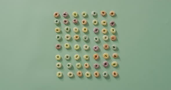 Video of colorful breakfast round cereals on blue background