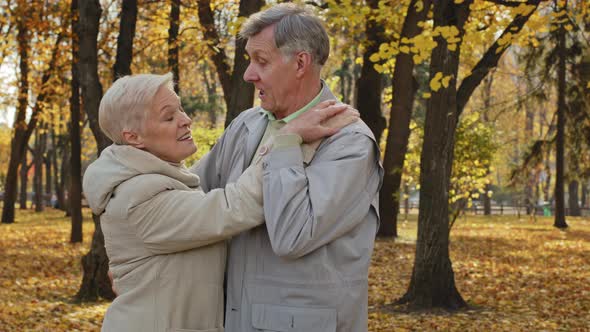 Happy Elderly Married Couple Dancing in Autumn Park Enjoy Romantic Dance Together Loving Old Middle