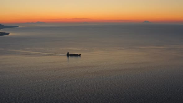 Silhouette of a small transport ship after sunset in Italy