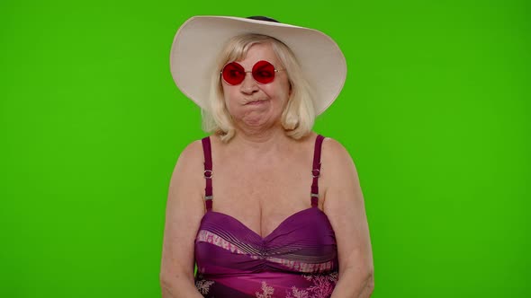 Funny Silly Senior Woman Tourist in Swimsuit Fooling Around Making Stupid Brainless Expressions