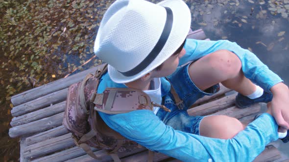 Traveler Boy Relax on the Pier Near the Lake Thinking About Something Cinematic