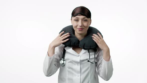 Sexy Female Doctor Puts on Sleeping Mask, Travel Pillow, Winks and Fall Asleep