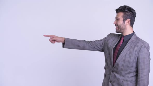 Profile View of Happy Bearded Persian Businessman Pointing Finger