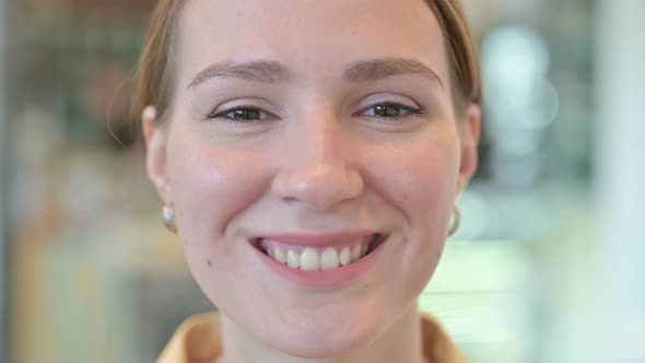 Close Up of Smiling Face of Young Woman 