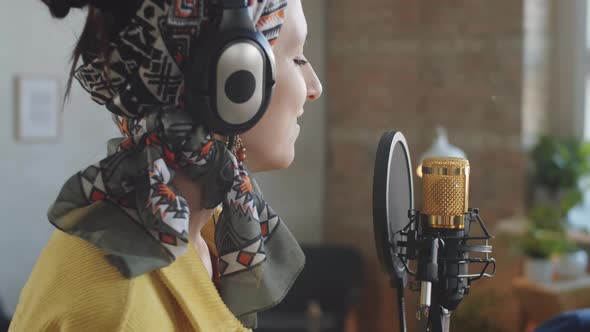 Woman in Headphones Singing in Mic during Online Livestream Concert