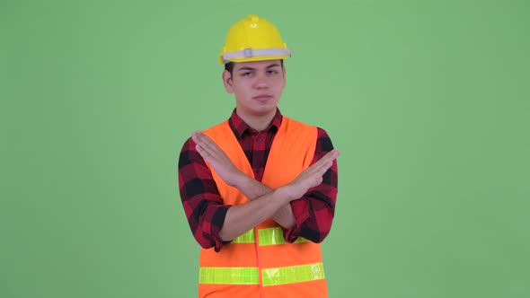 Serious Young Multi Ethnic Man Construction Worker with Stop Gesture