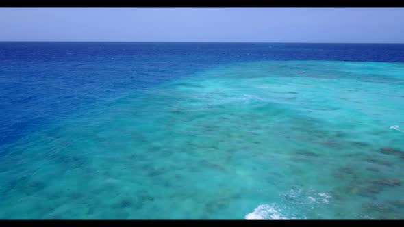 Aerial seascape of exotic seashore beach voyage by blue ocean and white sandy background of a dayout