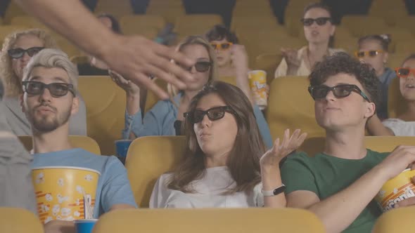 Engrossed People Watching 3d Film in Cinema As Unrecognizable Man Passing at Front. Portrait of