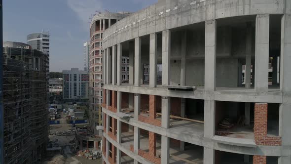 Aerial shot of construction of high-rise apartment buildings and cranes in city 06