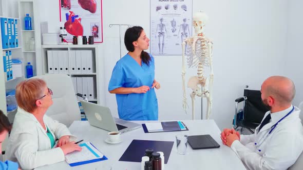 Nurse Giving Presentation Using Skeleton Model