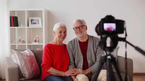 Happy Senior Couple with Camera Recording Video