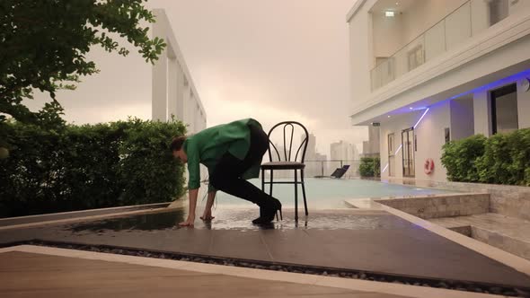 Dancer In Heels Crouching Then Going Into Splits At Poolside