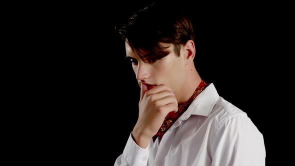 Androgynous man posing against black background