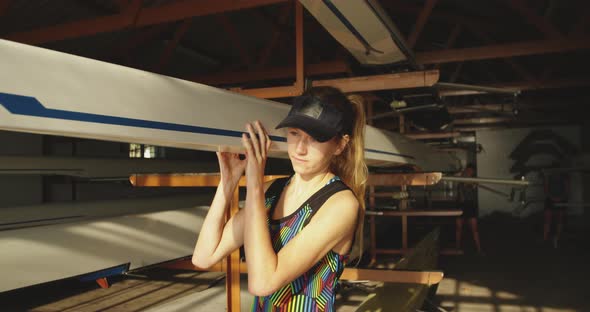 Female rower carrying a scull