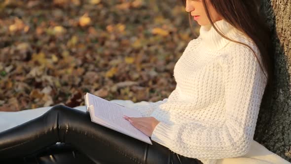 Girl Reading a Book in Park Woman