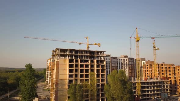 Aerial view of tall residential apartment buildings under construction.