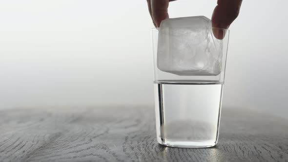 Slow Motion Making Espresso Tonic in Tumbler Glass Put Ice Cube Into Glass with Tonic