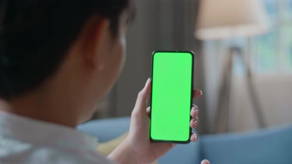 Close Up Of A Man Waving Hand And Talking To Green Screen Smartphone In The Living Room