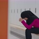 Young Upset Middle Eastern Muslim Woman Wearing Traditional Headscarf Sitting at Gym Locker Room - VideoHive Item for Sale