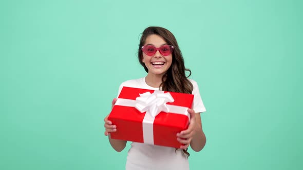Happy Surprised Child in Sunglasses Hold Present Box Shopping Sale