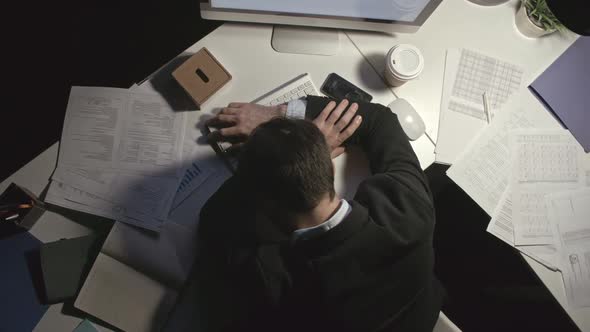 Man Sleeping at Workplace