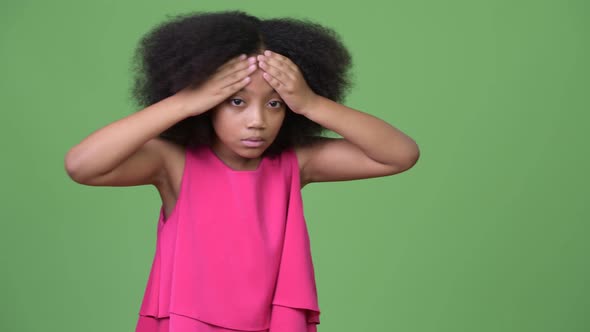 Young Cute African Girl with Afro Hair Having Headache