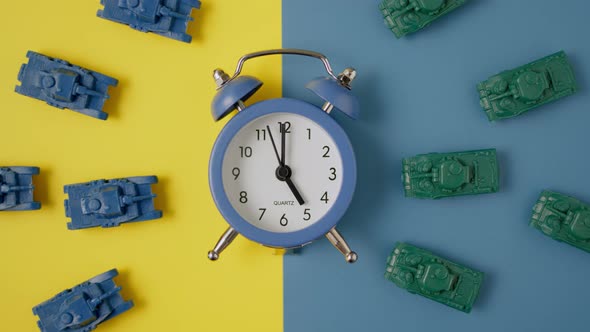 Yellow Retro Clock Lies on Yellow and Blue Background in Color of Flag of Ukraine Divided in Half