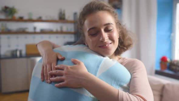 Diverse Young Man and Woman in Love Embracing at Home