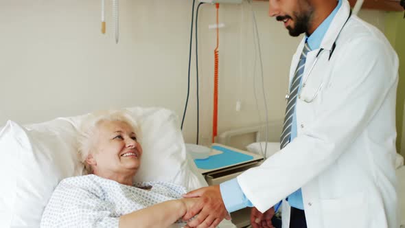 Doctor consoling senior patient