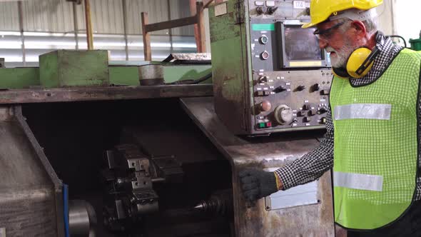 Senior Factory Worker Teach How to Use Machine Equipment in the Factory Workshop