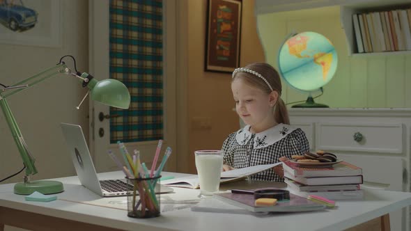 Schoolgirl Finishing Web Lesson and Having Online School Break with Milk and Cookies