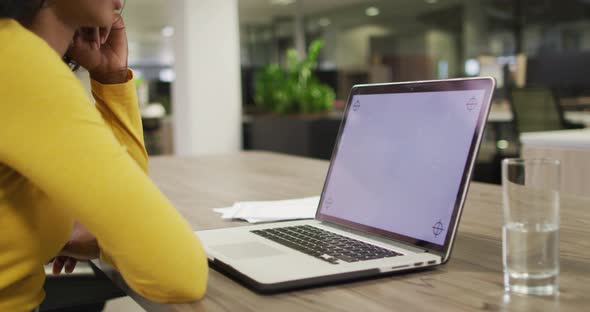 Video of biracial woman using laptop with copy space on screen