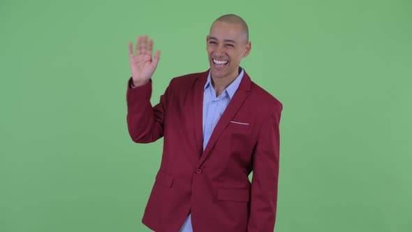 Happy Bald Multi Ethnic Businessman Waving Hand