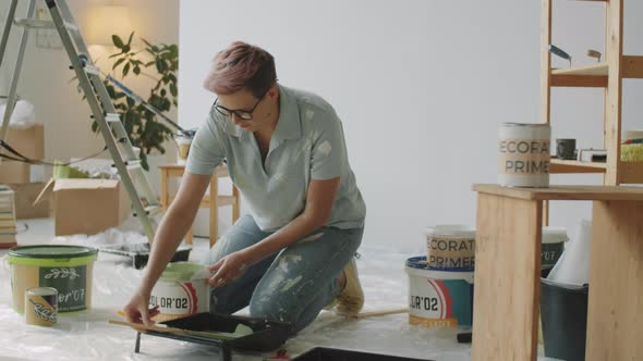 Woman Pouring Interior Paint into Tray