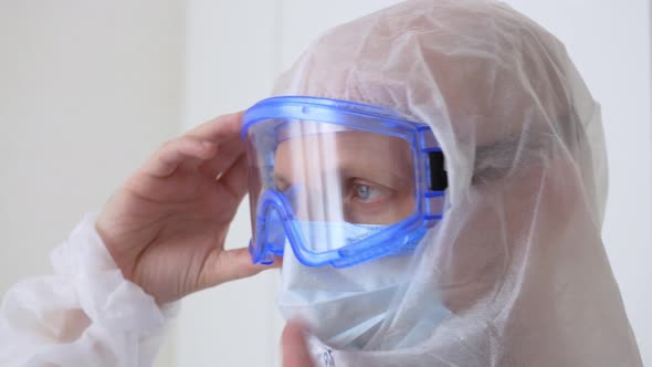 A Doctor Adjusts Protective Clothing Before Working in a Covid Hospital with Infected Patients