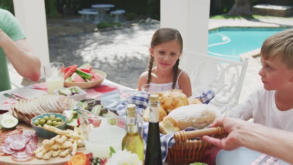 Happy family eating together at table