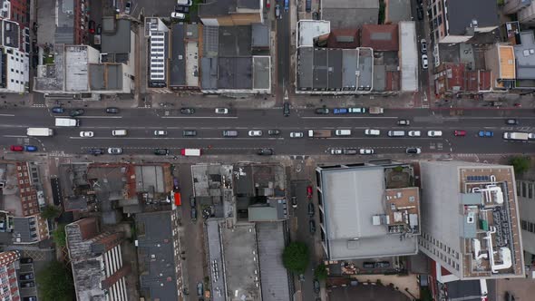 Aerial Birds Eye Overhead Top Down Panning View Cars Slowly and Intermittently Moving Through Street