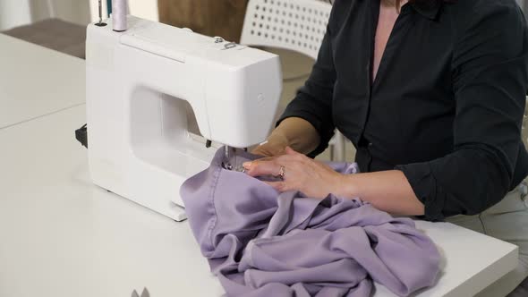 Seamstress Woman is Working on Sewing Machine in Tailoring Workshop Business