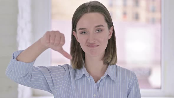 Portrait of Disappointed Young Woman Doing Thumbs Down