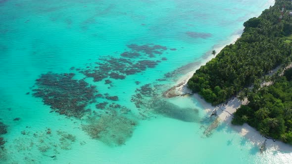 Luxury fly over travel shot of a sunshine white sandy paradise beach and aqua blue ocean background 