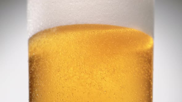 Extreme close-up beer in glass. Slow Motion.
