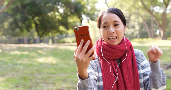 Woman making video call in the park