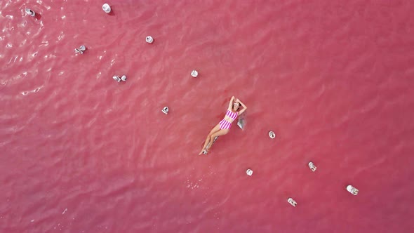 Woman Is Sunbathing in a Striped Bathing Suit