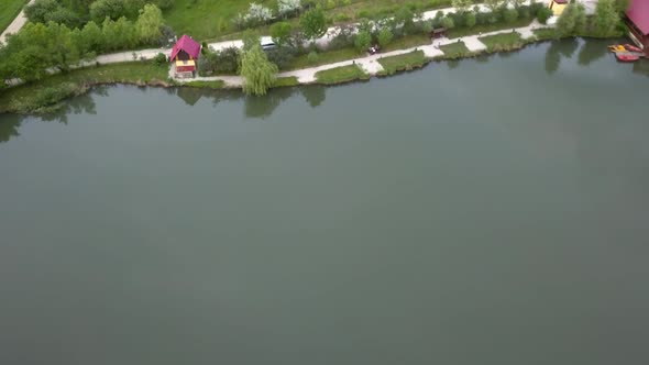 Aerial shot of a lake with tiny houses on the edge, Transylvania, Romania